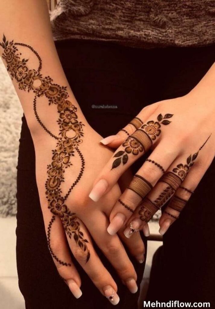 Elegant and modern trailing floral mehndi design extending along the wrist with delicate dotted chain details