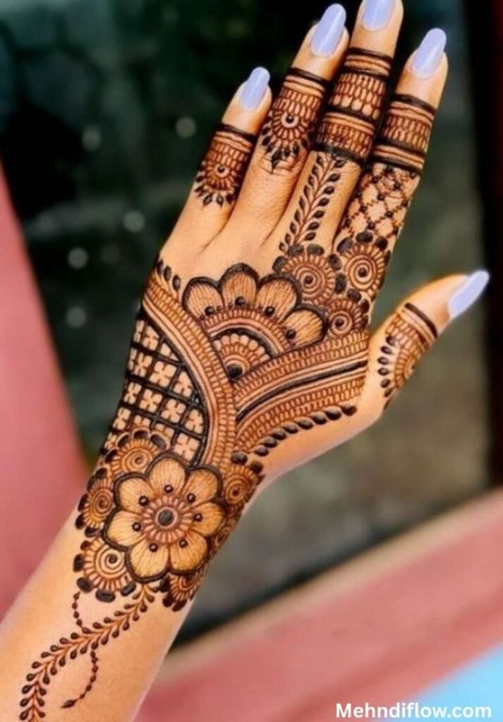 Bold Arabic back hand mehndi design with dark floral motifs and grid patterns