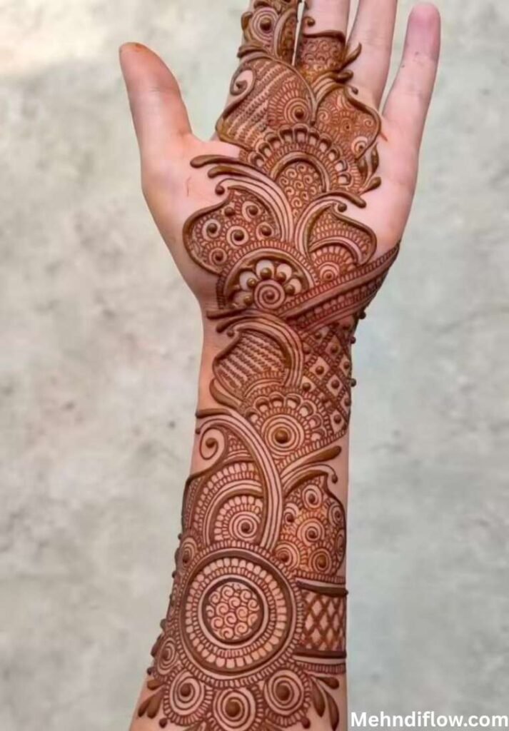 Arabic Bangle Mehndi Design featuring intricate floral and swirling patterns extending from the wrist up to the fingers, suitable as an engagement bangle mehndi design,