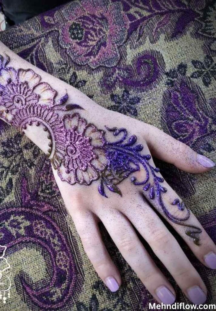 Heavy bridal purple glitter mehndi design with a thick silver-glitter wristband cuff and intricate swirls.