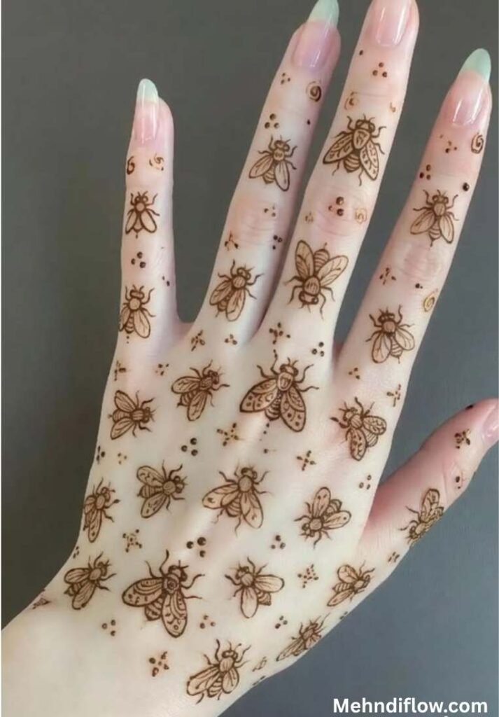 A scattered pattern of tiny, simplistic butterfly motifs dotted across the back of the hand and fingers.