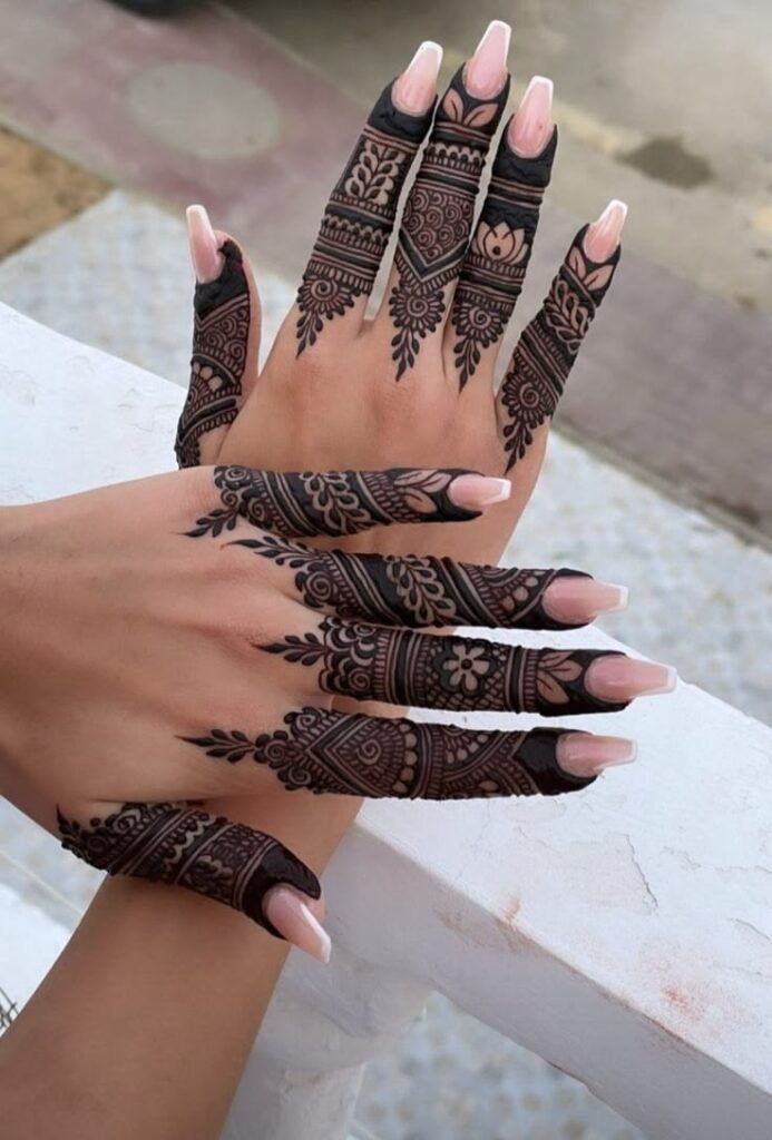 Dark intricate henna bands and geometric patterns strictly on the fingers.