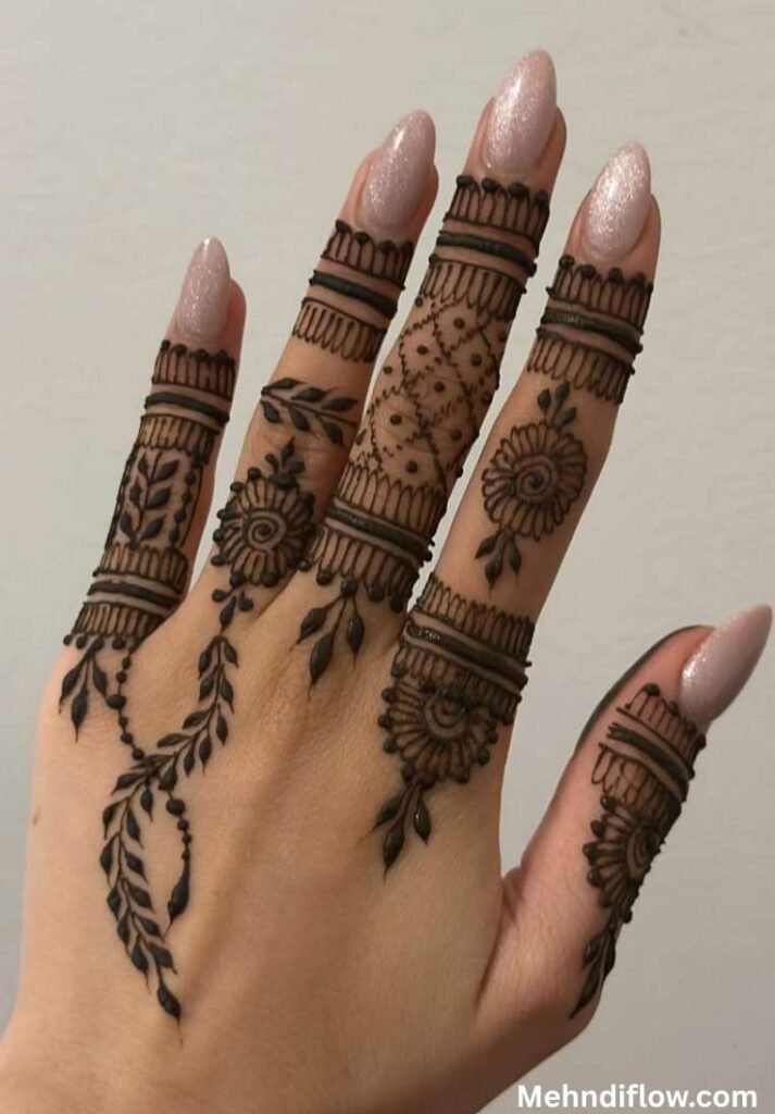 Detailed finger mehndi design with geometric patterns, small flower motifs, and trailing vine accents