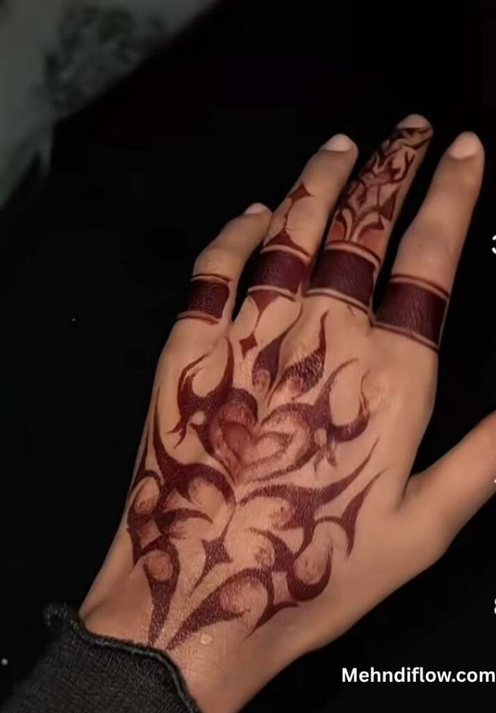 A hand featuring a bold, tribal-inspired mehndi design on the back of the hand, paired with simple, thick henna bands on the fingers.