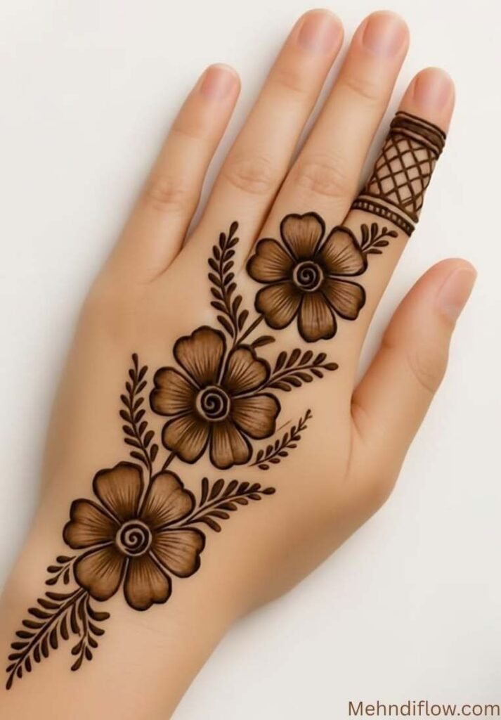 Minimalist back hand mehndi design featuring a diagonal trail of three shaded flowers and a geometric grid pattern on the index finger. - Instagram Stylish Back Hand Mehndi Designs 