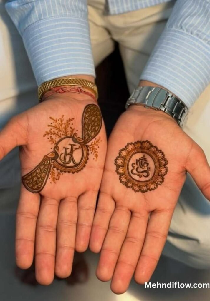 Two palms held side-by-side, each displaying a minimalist groom's mehndi design: one with a peacock feather motif incorporating initials, and the other with a circular Ganesha medallion.