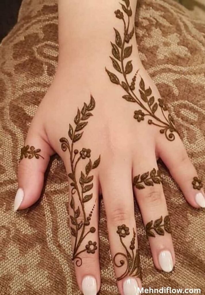 Hand featuring a graceful leaf vine mehndi design extending from the wrist to the fingers.
