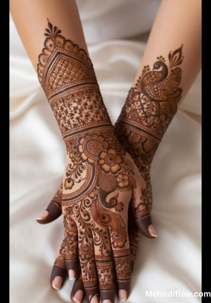 A pair of hands adorned with intricate mehndi, featuring prominent floral motifs, leafy vines, and delicate detailing that extends from the wrists to the fingertips.