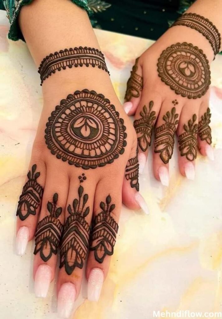 Classic central mandala henna design with pointed finger motifs and a banded wrist pattern.