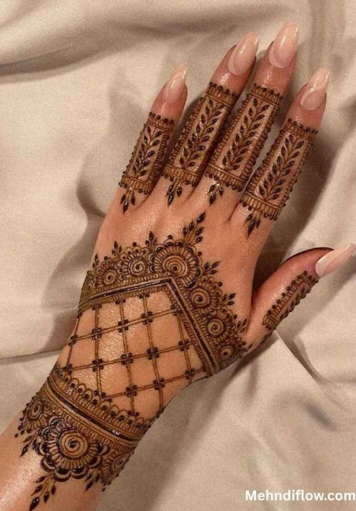 A close-up of a single hand displaying a minimalist bridal mehndi design, featuring a structured net pattern covering the mid-hand, complemented by dainty leaf motifs on the fingers and a refined scalloped border at the wrist.