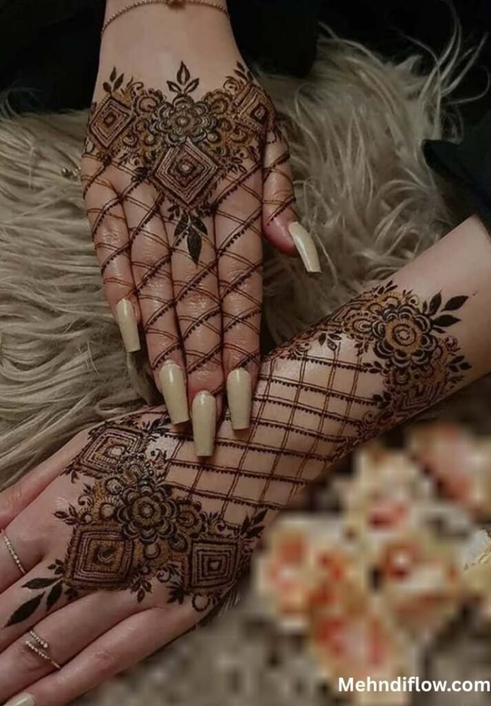 A pair of hands featuring a modern, minimalist royal net mehndi design that combines delicate la