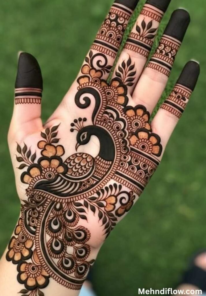 Elegant Rajasthani bridal mehndi design on a palm highlighting a large, graceful peacock motif with leaf accents. - raj mehndi design