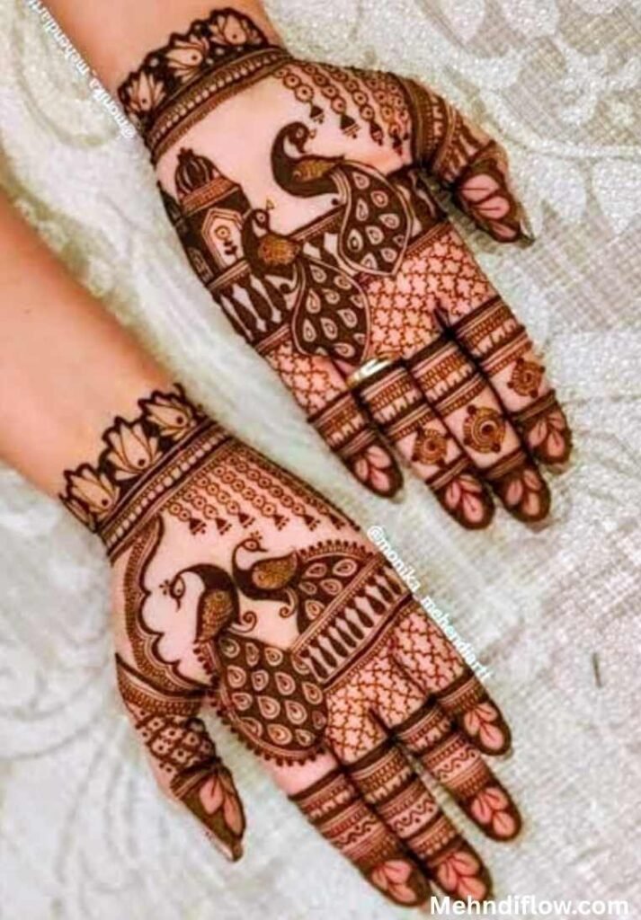 Intricate Rajasthani bridal mehndi design on both hands featuring prominent peacock motifs and detailed jali mesh patterns. - raj mehndi design