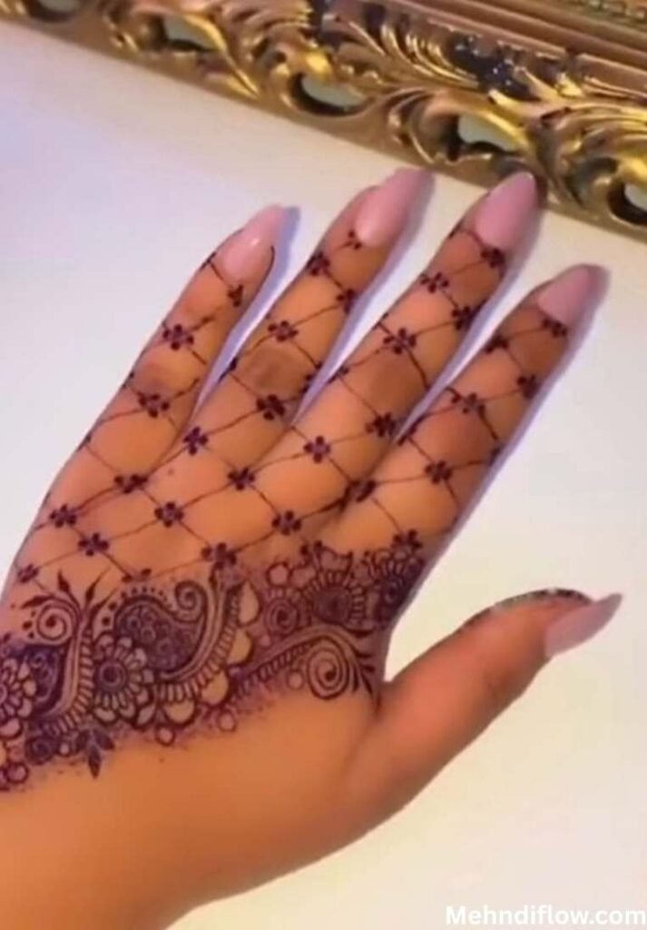 Elegant purple glitter mehndi design featuring a delicate net mesh pattern on fingers and intricate paisley wrist art.