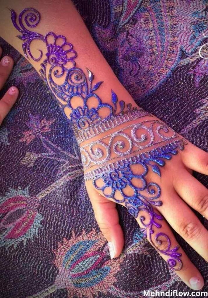 Intricate purple glitter mehndi design covering the wrist and back of the hand with elaborate swirls. - purple glitter mehndi design 
