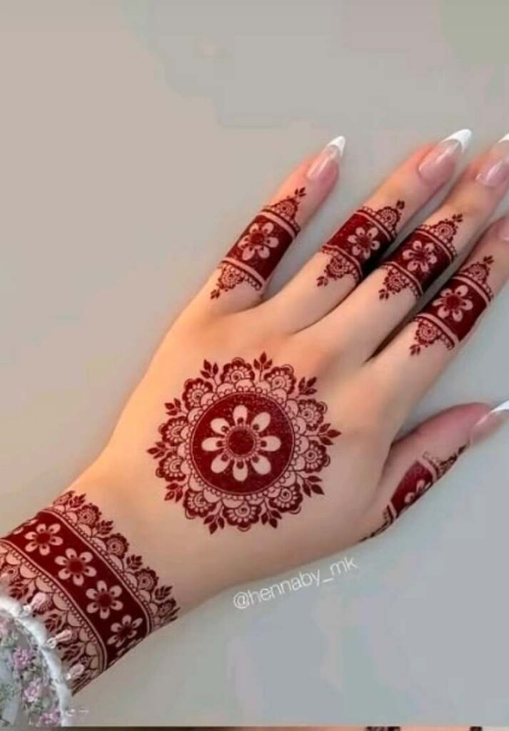 Minimalist 2026 back hand mehndi trend featuring a perfectly symmetric circular mandala in the center of the hand and heavily stained crimson fingertips. - Basic Easy Front Hand Simple Mehndi Design