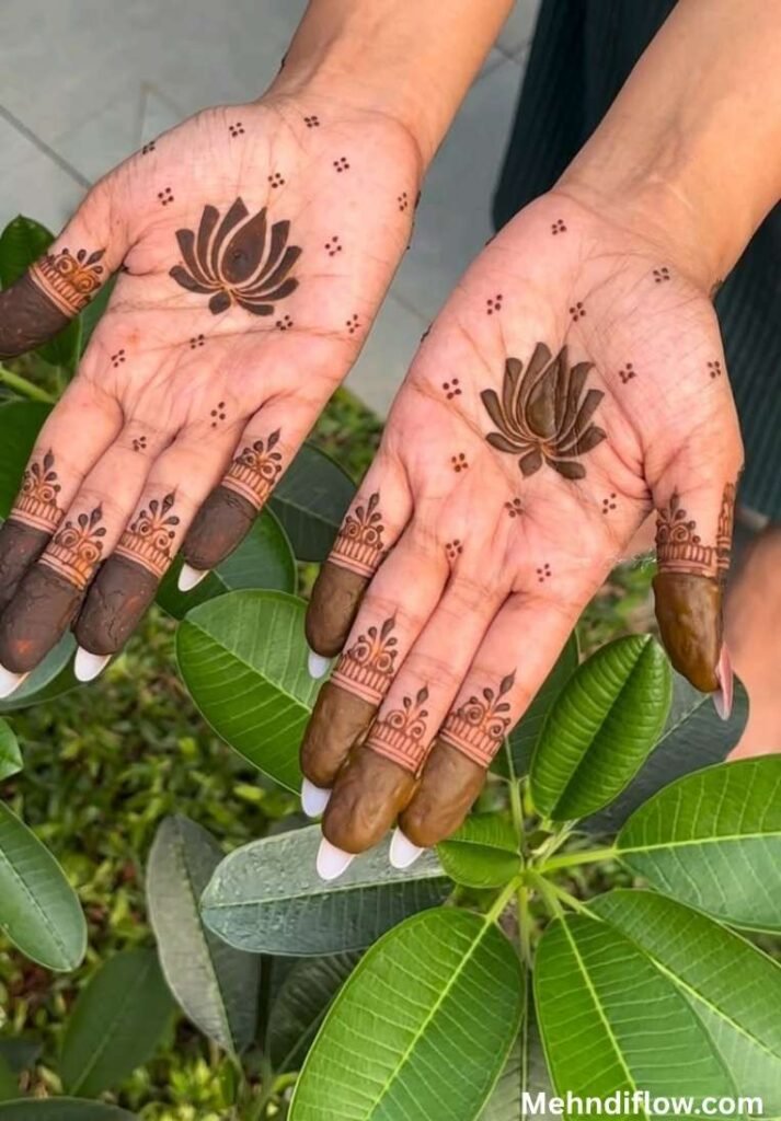 Simple 5-petal lotus mehndi design on both palms with tiny cross-dot patterns and capped fingertips.