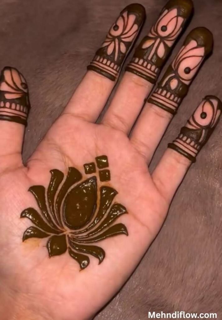 Bold 8-petal lotus mehndi design on the palm with three small square accents and detailed fingertip art.