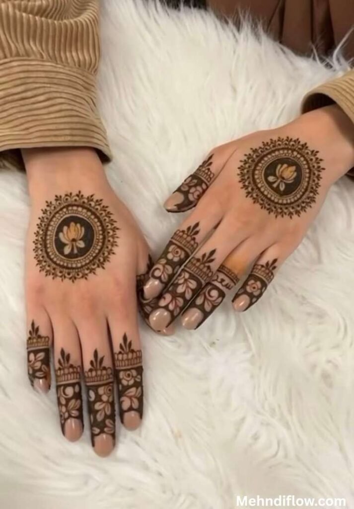 Minimalist mandala circle mehndi design on the back of the hands featuring an elegant center lotus flower and delicate half-finger floral accents.