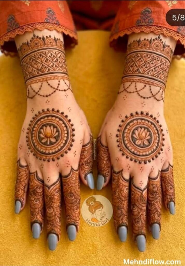 Elegant back-of-hand bridal lotus mehndi with geometric mandala circles and wide mesh wrist cuffs.