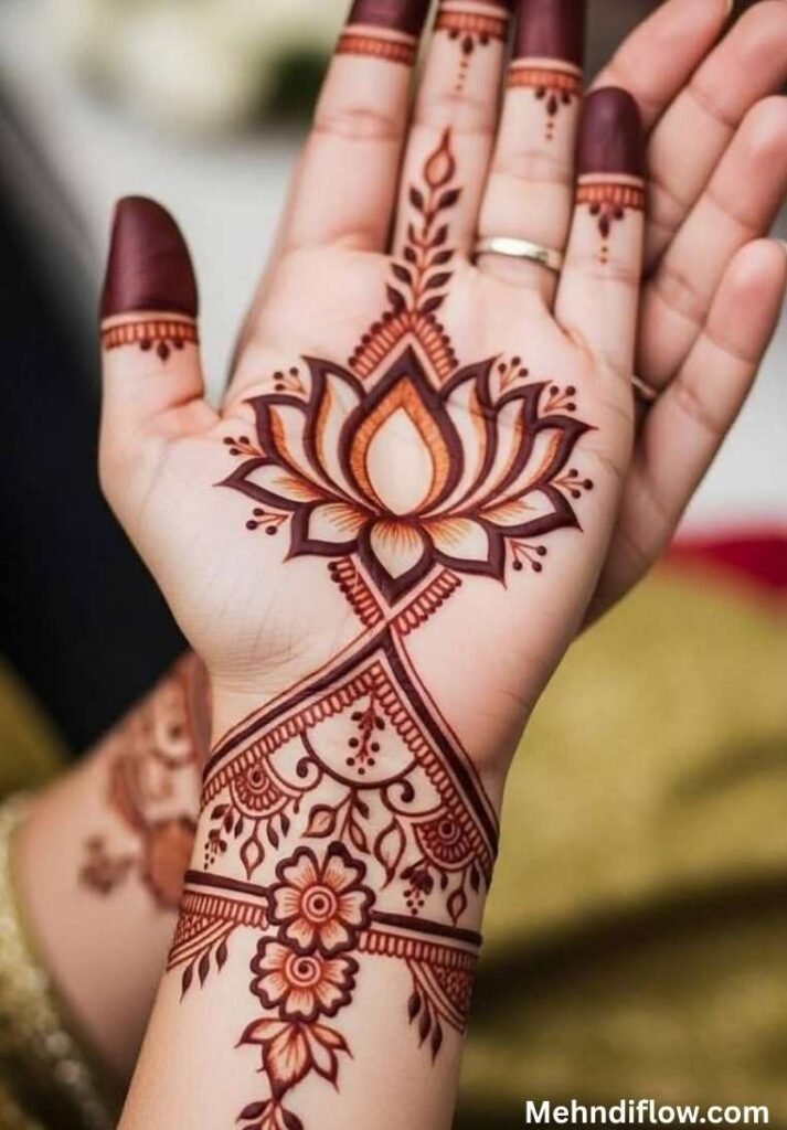 Festive bridal lotus mehndi design on the palm with a detailed ornamental wrist cuff pattern.