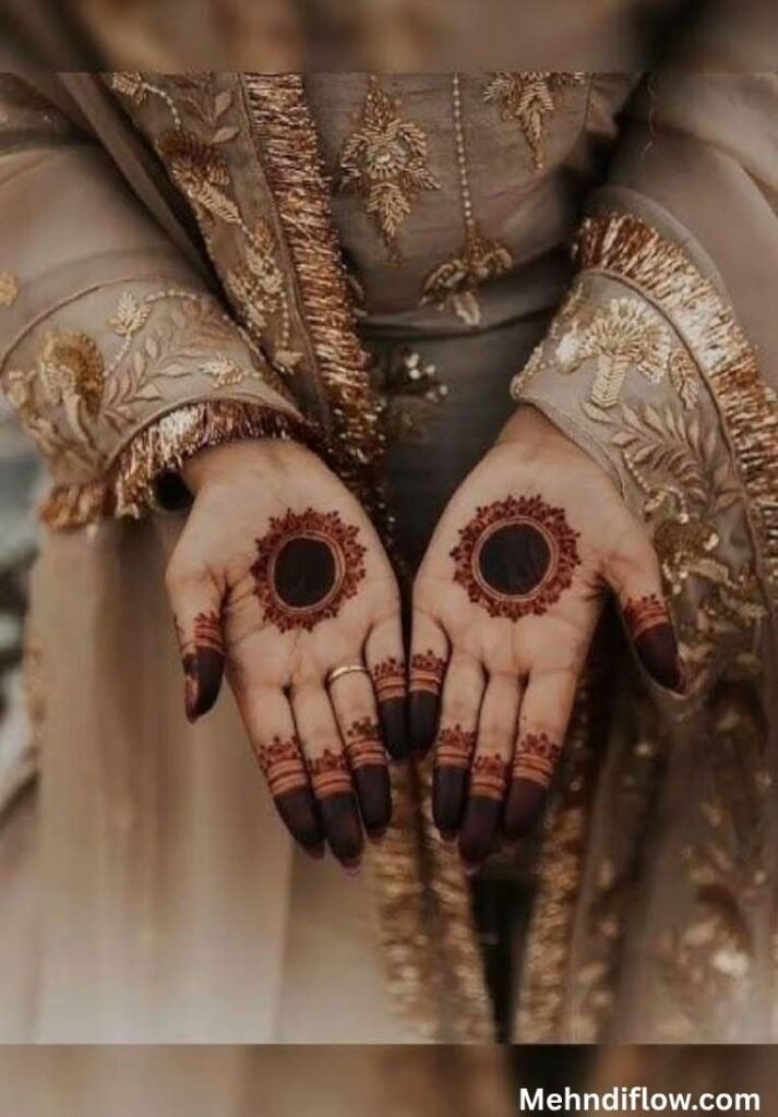 Simple Gol Tikki mehndi design on the palms with minimalist dark circles and capped fingers.