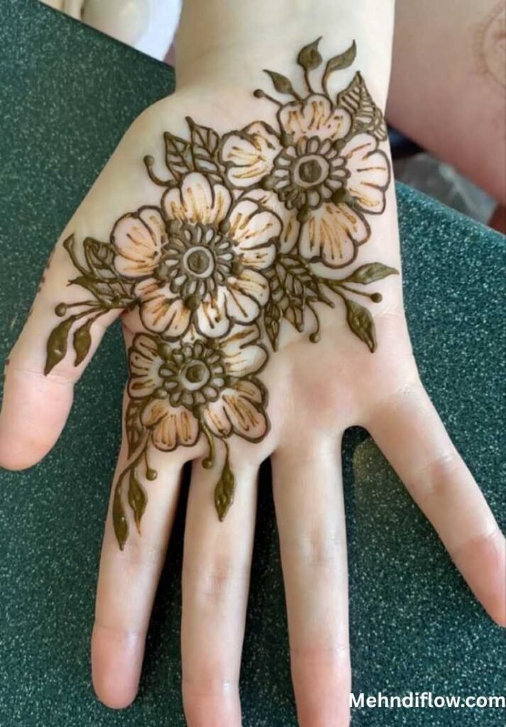 Intricate half palm raj mehndi design showcasing a dense central cluster of layered round blooms and detailed leafy branches on the palm.