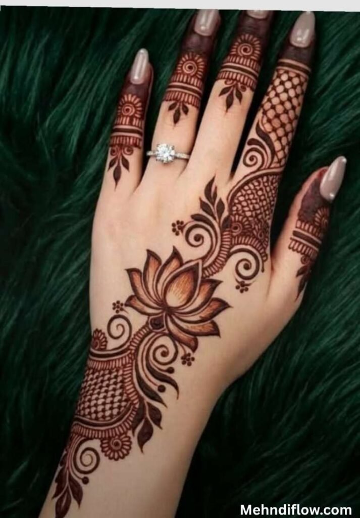 Elegant Arabic style lotus mehndi design on the back of the hand with shaded swirls and mesh details.