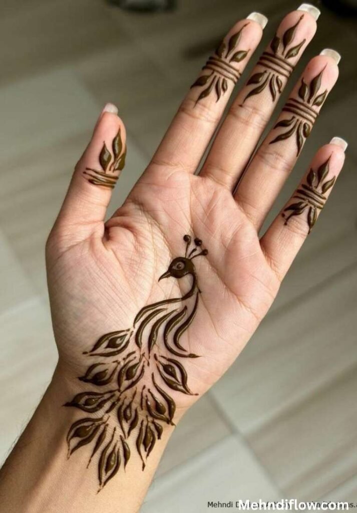 Minimalist peacock henna design on the palm with elegant leaf-patterned finger details.