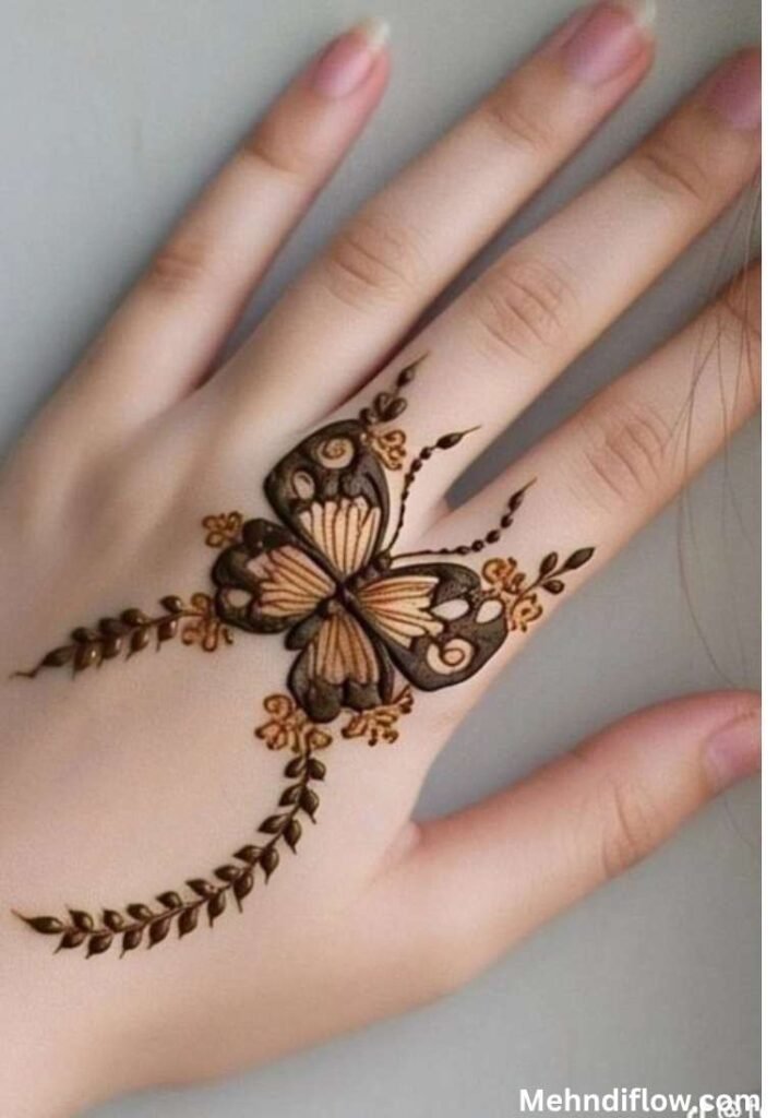 Charming butterfly henna design on the back of the hand with trailing leafy vines and tiny floral accents.