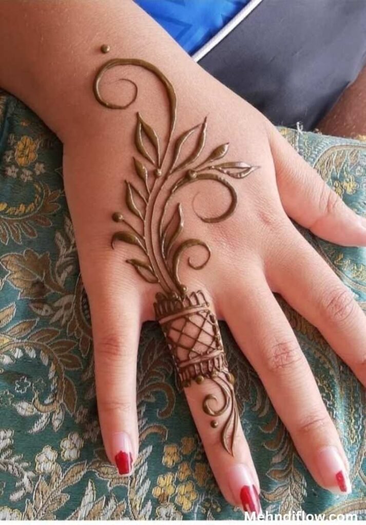 Elegant raj mehndi design on the back hand featuring a sweeping leafy vine, traditional swirls, and intricate mesh netting extending down the middle finger.