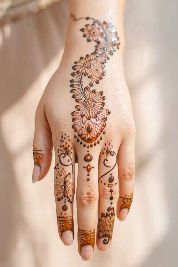 Delicate Khafif mehndi design with fine flowers, paisleys, and leafy vines