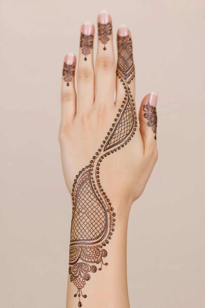 Back hand net mehndi design with floral and paisley details