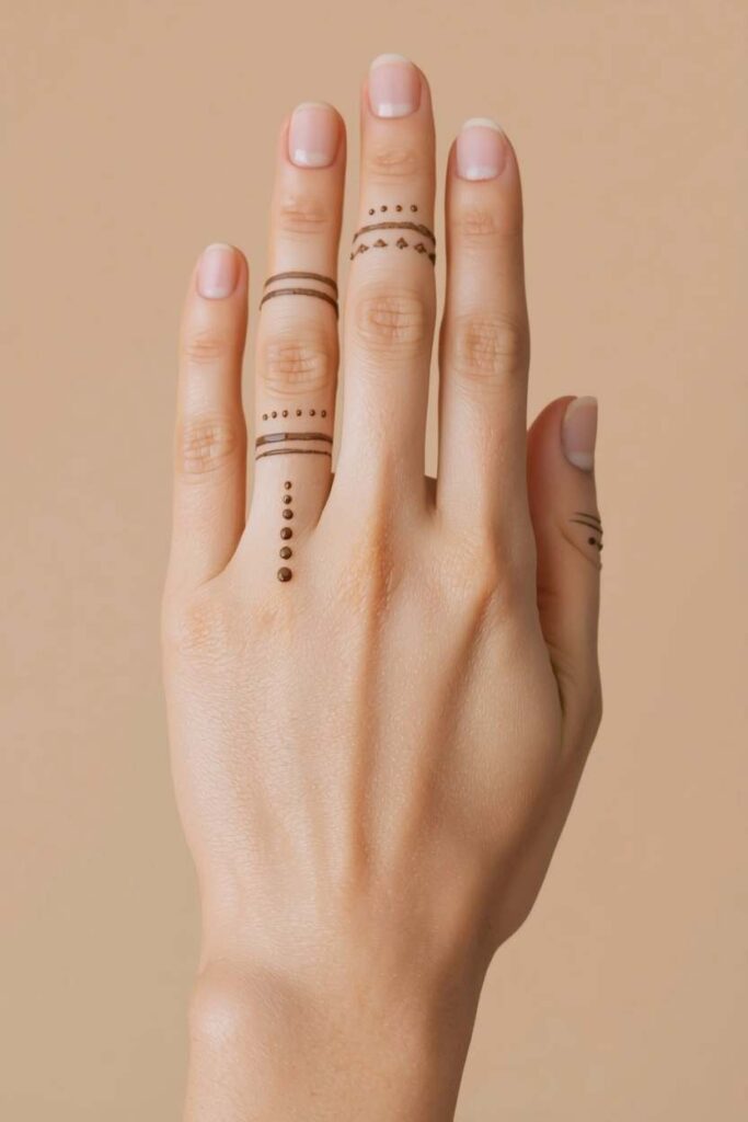  Boys back-hand mehndi design with a geometric wristband and small motif.
